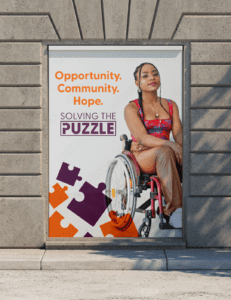 Solving The Puzzle Logo showing girl in wheelchair given opportunities to succeed