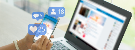 Laptop and phone showing page likes, comments, and friend request notification bubbles for social media
