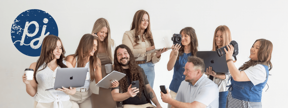 where-ai-helps-hurts-marketing-strategy-creative-marketing-team Creative marketing team using laptops, cameras, and mobile devices while collaborating on AI-powered marketing strategy and content creation.
